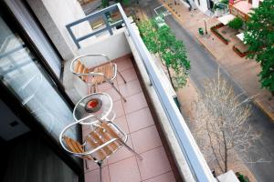 an overhead view of two chairs on a balcony at Tempo Rent Apart Hotel in Santiago