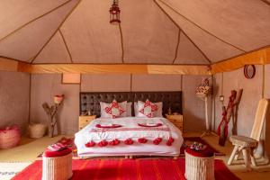 a bedroom with a bed in a tent at Sanmao Royal Camp 皇家营地 in Merzouga