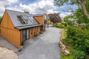 a small house with a pathway leading to it at Maes-Y-Caerau in Criccieth