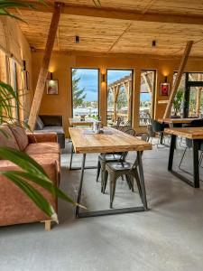 a living room with a wooden table and a couch at Domki Marina Rydzewo in Rydzewo