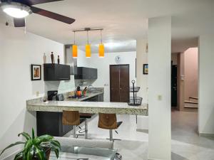 a kitchen with a large island in a room at Casa Serena in Cancún