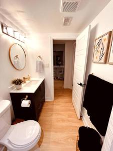 a bathroom with a white toilet and a sink at Nala's Lake House Retreat in Combermere