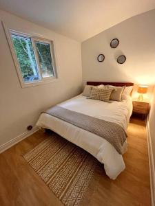 a bedroom with a large bed and a window at Nala's Lake House Retreat 