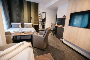 a hotel room with two beds and a flat screen tv at Sunshine apartments - Valjevo in Valjevo