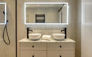 a bathroom with two sinks and a mirror at Kist Accommodates presents - Hygge House in Ripon