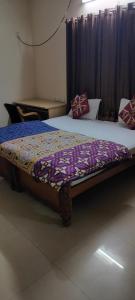 a bedroom with two beds with a comforter on it at Service Apartment Near Rameshwaram Cafe Brookefield in Bangalore