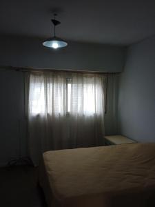 una camera con letto e finestra con luce di Hospedaje La Feliz a Mar del Plata