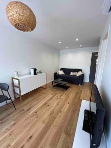 - un salon avec un canapé et une table dans l'établissement Superbe appartement, terrasse, accès direct RER, à Massy