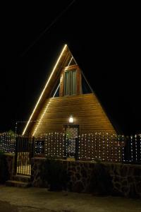 a house with lights on the side of it at night at Panorama BatumGora in Batumi