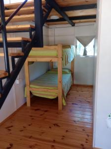 a room with bunk beds in a tiny house at Cabañas Guayacán in Bialet Massé +18 photos