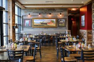 a dining room with tables and chairs and a painting on the wall at Great Wolf Lodge Colorado Springs in Colorado Springs