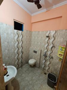 a bathroom with a toilet and a sink at Sunlit stays-Forest view in Lucknow