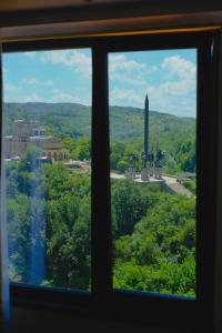 a window looking out at a view of a monument at Apartments Panorama in Veliko Tŭrnovo