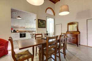 a kitchen and dining room with a wooden table and chairs at Route26 - Florence in Florence