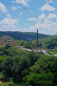 a view of a monument in the middle of trees at Apartments Panorama in Veliko Tŭrnovo