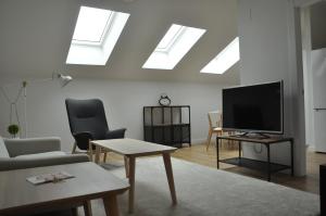 a living room with a flat screen tv and skylights at San Bernardo, 19 in Avilés