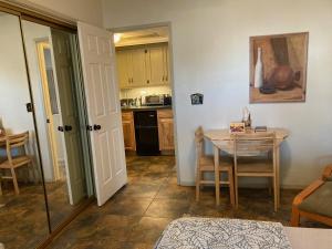 a kitchen with a table and a dining room at Desert retreat close to downtown/ U of A, 1-10 in Tucson