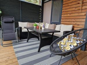 a patio with a table and chairs and a couch at Mobile Home Kailani Nr 121, Camping Porton Biondi in Rovinj