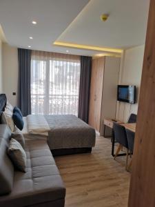 a hotel room with a bed and a couch at Harmony, Residence Hill A85 in Kopaonik