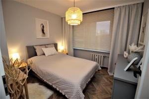 Giường trong phòng chung tại Apartament Kaszmirowy
