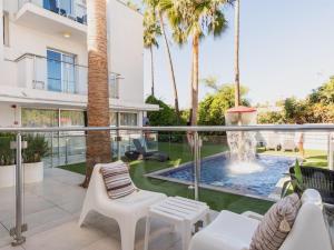 a patio with a fountain and chairs and a house at Rio Gardens Aparthotel in Ayia Napa