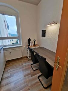 a dining room with a table and a window at Ferienwohnung Winzer in Annaberg-Buchholz