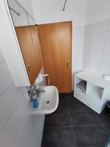 a bathroom with a sink and a toilet and a mirror at Ferienwohnung Winzer in Annaberg-Buchholz