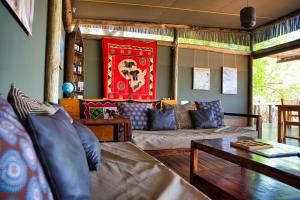 a living room with a couch and a table at Semowi Lodge and Campsites in Mirapene
