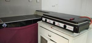 a kitchen with a stove top on top of a counter at Dar marruecos in Kasba Mohammed Ou Addi