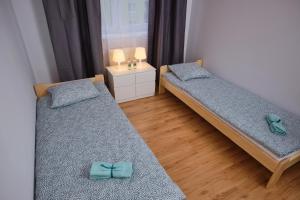 Ένα ή περισσότερα κρεβάτια σε δωμάτιο στο Apartament Słoneczny 12
