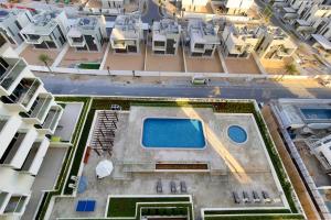 an aerial view of a building with a swimming pool at Azizi Luxurious 1 Bed Room apartment, Near Metro, Fully Furnished in Dubai