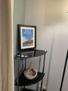 a shelf with a picture and a vase on it at April Disc - Long Stay - Contractors in Bristol