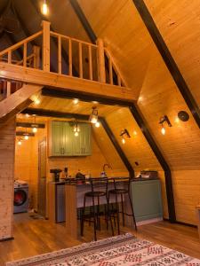 an attic kitchen with a wooden ceiling with a staircase at Ashla A-Frame Lenkaran in Lankaran