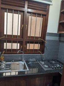 a kitchen with a sink and a stove at Richmond Hill SHA Residencies in Galle
