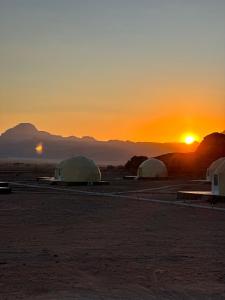 a group of tents in the desert at sunset at Nasem rum in Wadi Rum