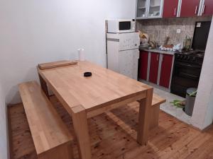 a kitchen with a wooden table in a kitchen at Vila Ružica in Kupres