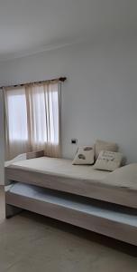 a large bed in a room with a window at Center Cruz del Eje in Cruz del Eje