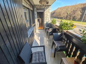 a row of benches sitting on a porch at Apartment Prešeren in Smarjeske Toplice