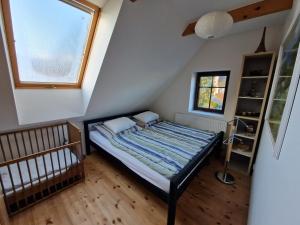 a small bedroom with a bed and a window at Chalupa U potoka in Červená Voda