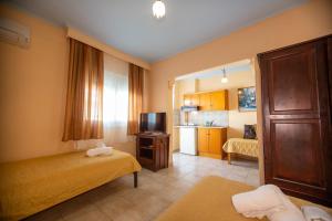a hotel room with a bed and a television at Xenia Palace luxury apartments in Nea Vrasna