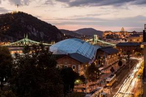 a city with a bridge and a train station at Luxurious Danubeside Apartment for 6 in Budapest