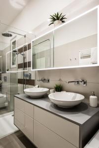 two sinks on a counter in a bathroom at Luxurious Danubeside Apartment for 6 in Budapest