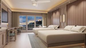 a hotel room with two beds and a desk at JW Marriott St Maarten Beach Resort & Spa in Dawn Beach +37 photos