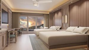 a hotel room with two beds and a television at JW Marriott St Maarten Beach Resort & Spa in Dawn Beach