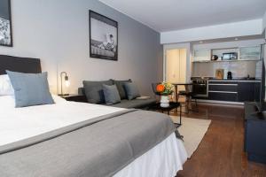 a bedroom with a large bed and a living room at Malvon Beautiful Suite in Buenos Aires