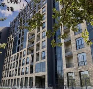 a tall building with windows on the side of it at Tsaghkadzor View Апартамент с видом на горы in Tsaghkadzor