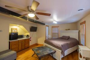 a bedroom with a bed and a ceiling fan at Stay In Ohiopyle in town by the GAP trail in Farmington