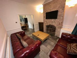 a living room with a couch and a fireplace at Bolsover Castle View in Bolsover