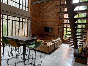 a living room with a table and chairs and a couch at Le Patio in Lomé