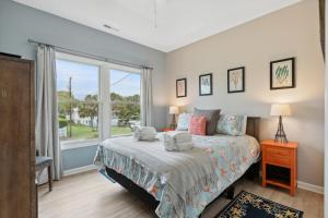 a bedroom with a bed and a window at BeachZilla - 907 East Arctic in Folly Beach